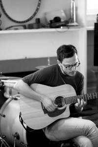 Black and white Tom with his guitar.